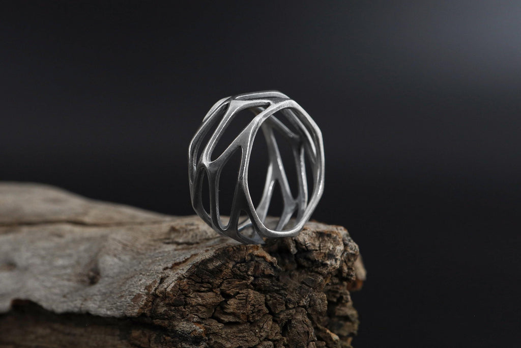 Geometric cage ring, perforated wide band ring, modern openwork band ring, and handcrafted statement ring designed for those who are drawn to bold structure, architectural design, and contemporary aesthetics. This striking ring features a geometric cage-inspired form with perforated cut-out details, creating a look that feels modern, edgy, and visually dynamic