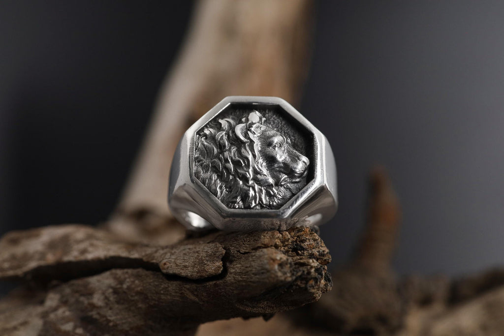 African lion signet ring, sterling silver safari animal jewelry, symbolic king lion statement band, and handcrafted bold accessory designed for those who are drawn to courage, leadership, and untamed strength. This striking ring features a detailed African lion motif framed within a bold signet structure, creating a look that feels regal, masculine, and deeply symbolic