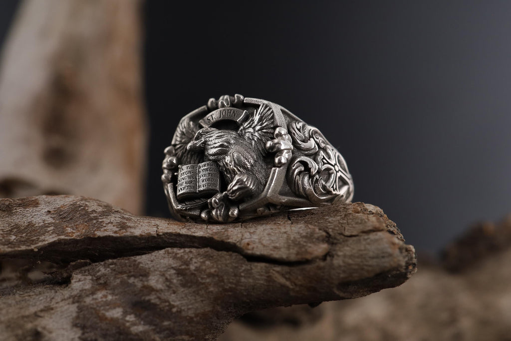 St. John eagle signet ring, sterling silver Christian jewelry, symbolic religious statement band, and handcrafted bold accessory designed for those who are drawn to faith, wisdom, and spiritual strength. This striking ring features a detailed eagle motif inspired by Saint John symbolism, framed within a bold signet structure that creates a look both sacred and powerful.