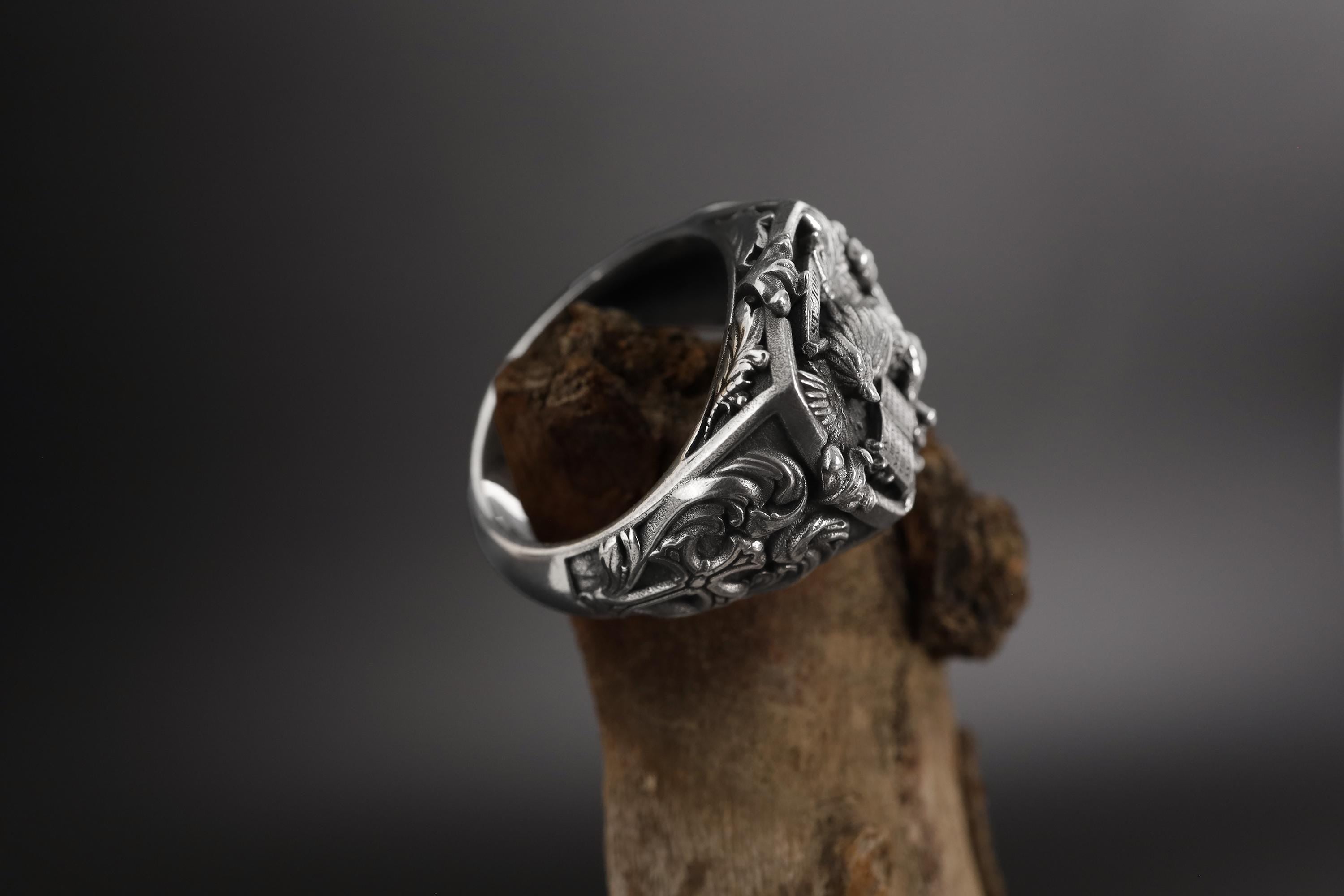 St. John eagle signet ring, sterling silver Christian jewelry, symbolic religious statement band, and handcrafted bold accessory designed for those who are drawn to faith, wisdom, and spiritual strength. This striking ring features a detailed eagle motif inspired by Saint John symbolism, framed within a bold signet structure that creates a look both sacred and powerful.