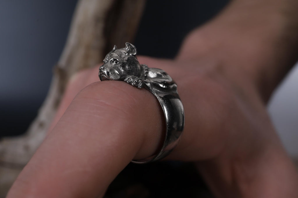 Pitbull head ring, dog inspired statement jewelry, symbolic warrior accessory, and handcrafted bold band designed for those who are drawn to loyalty, strength, and fearless character. This striking ring features a detailed pitbull head motif with muscular facial details and textured engraving, creating a powerful appearance inspired by the strong and protective nature of the pitbull breed.