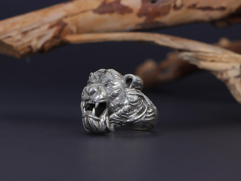 Roaring tiger head ring, sterling silver fierce statement jewelry, symbolic tiger signet band, and handcrafted bold accessory designed for those who are drawn to strength, courage, independence, and untamed energy. This striking ring features a detailed roaring tiger head motif framed within a bold statement structure, creating a look that feels wild, fearless, and deeply symbolic.