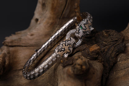 Silver Panther bracelet for men, sterling silver panther bracelet, panther head jewelry, luxury animal bracelet, men's statement bracelet, and handcrafted bold accessory designed for those who appreciate strength, confidence, and timeless craftsmanship. This striking bracelet features detailed panther heads connected by an intricately textured band, creating a commanding design inspired by the elegance, agility, and dominance of one of nature